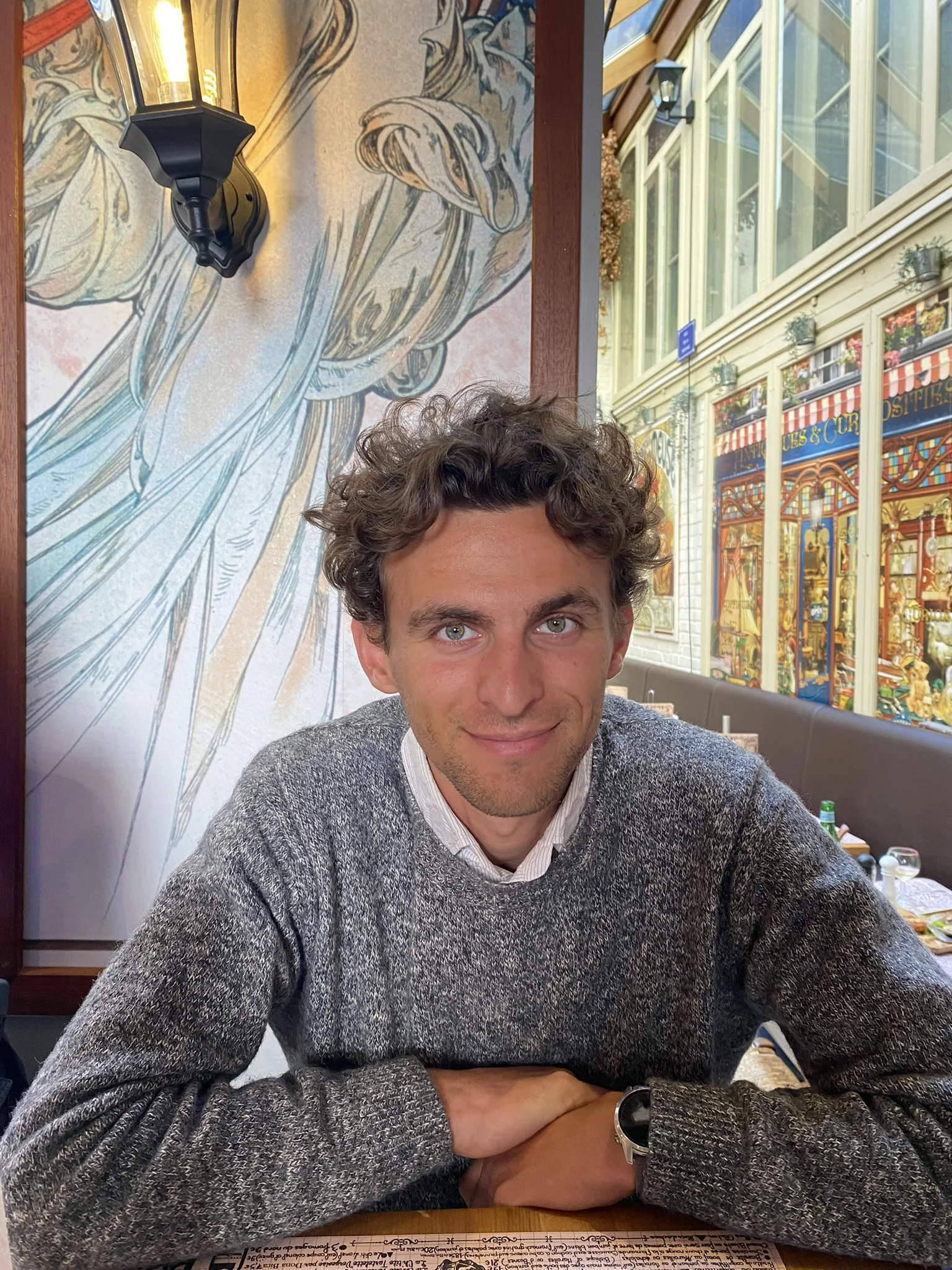 Tibo Vanleke smiling across a café table.