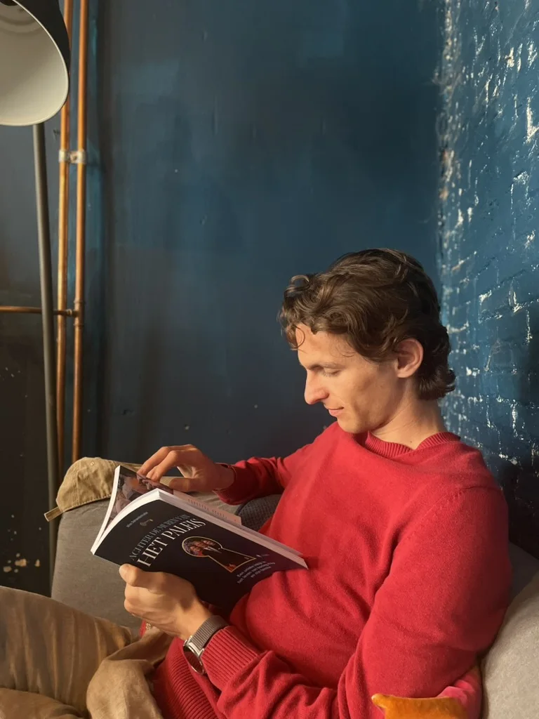Tibo Vanleke reading in the afternoon light.
